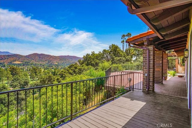 a view of a balcony with wooden floor