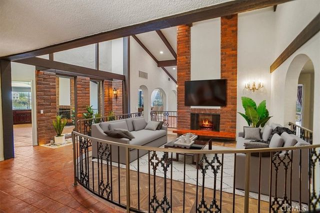 a living room with furniture fireplace and flat screen tv