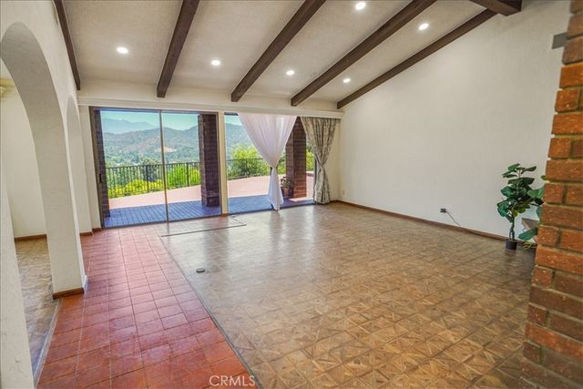 an empty room with large windows