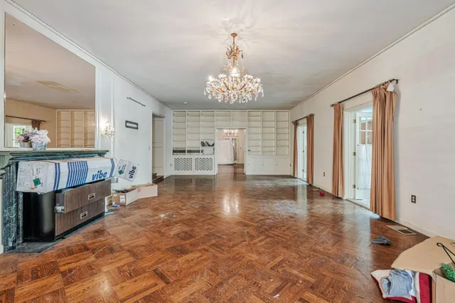 a large kitchen with a stove a refrigerator a sink dishwasher with wooden cabinets and dining table with dishwasher