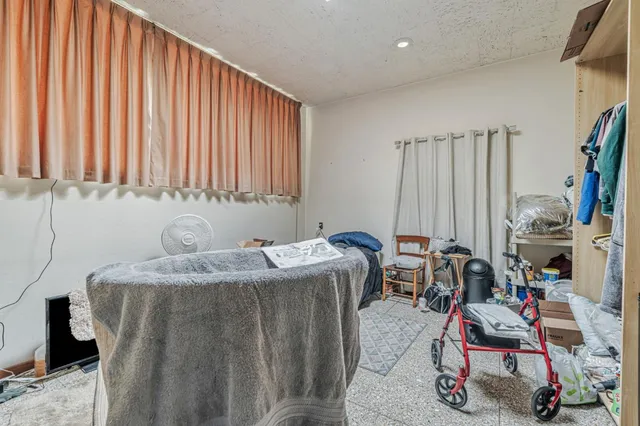 a bedroom with furniture and a flat screen tv