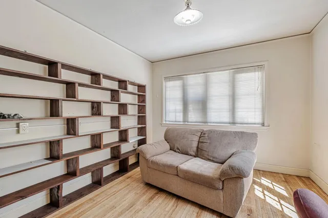 a spacious bedroom with a bed and a chandelier