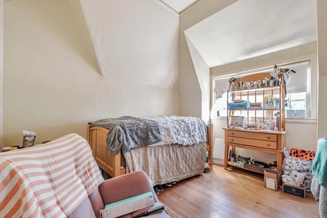 a spacious bedroom with a bed a table and chair