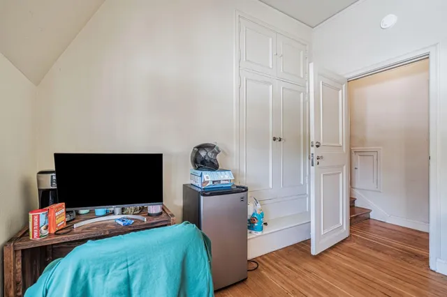 a bedroom with a bed and a flat screen tv