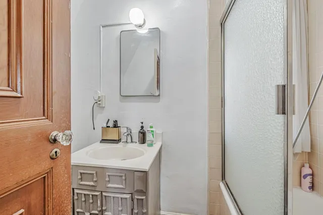 a bathroom with a tub a sink and a mirror