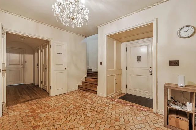 a view of a bedroom with a bed and chandelier