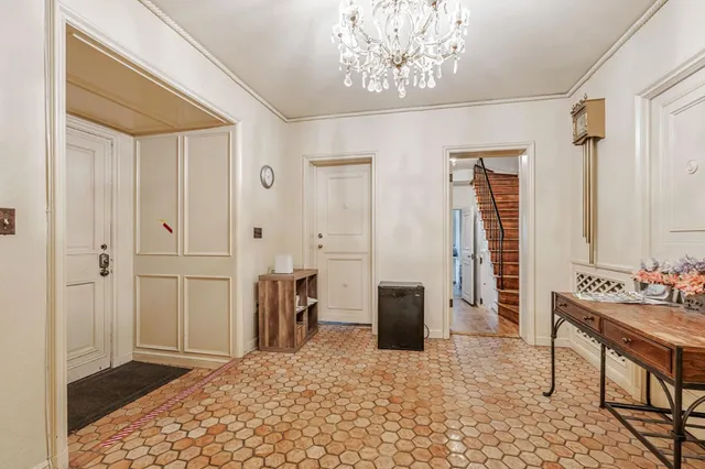 a view of a livingroom with dining space and a large window