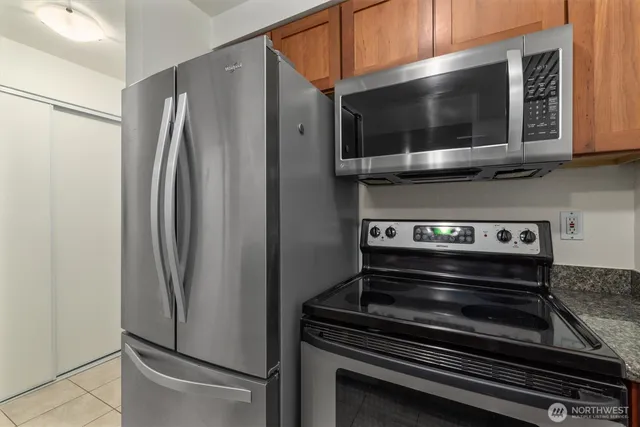 a kitchen with a refrigerator stove and microwave