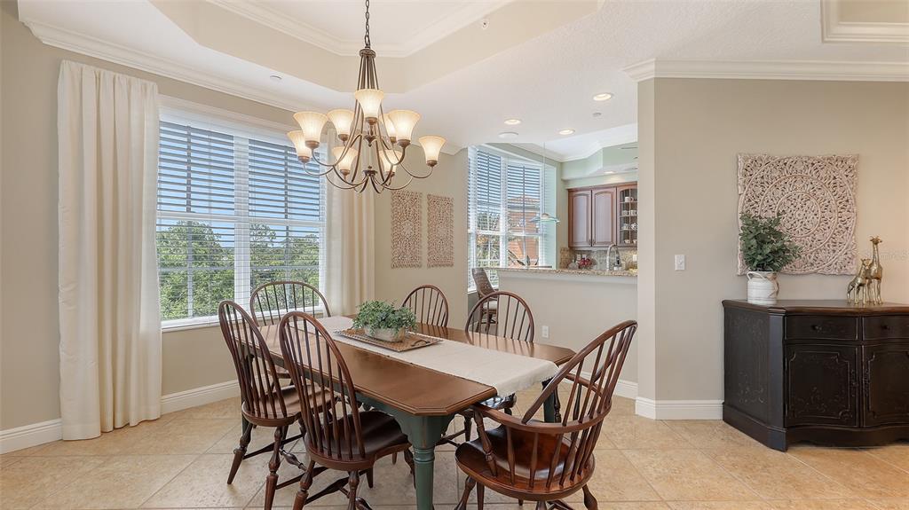 6465 Water Crest Way, Unit 404 Lakewood Ranch, FL 34202 - Photo 15 of 62 a view of a dining room with furniture window and outside view