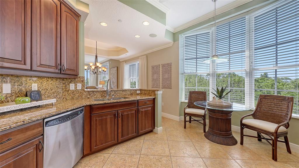 6465 Water Crest Way, Unit 404 Lakewood Ranch, FL 34202 - Photo 19 of 62 a kitchen with a sink and cabinets