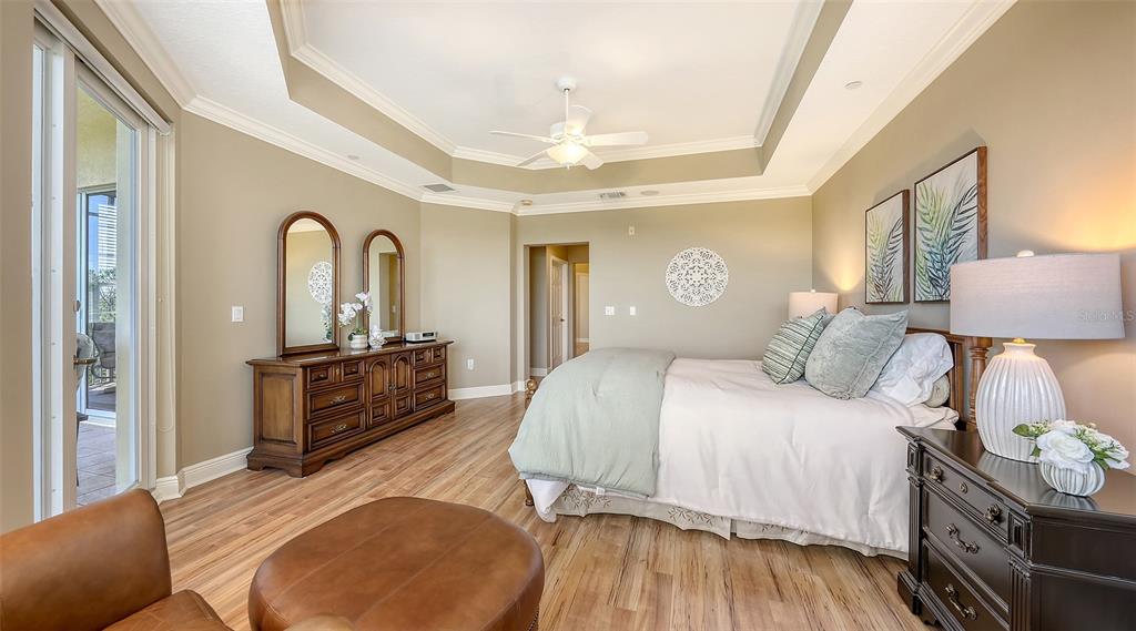 6465 Water Crest Way, Unit 404 Lakewood Ranch, FL 34202 - Photo 25 of 62 a bedroom with a bed and wooden floor