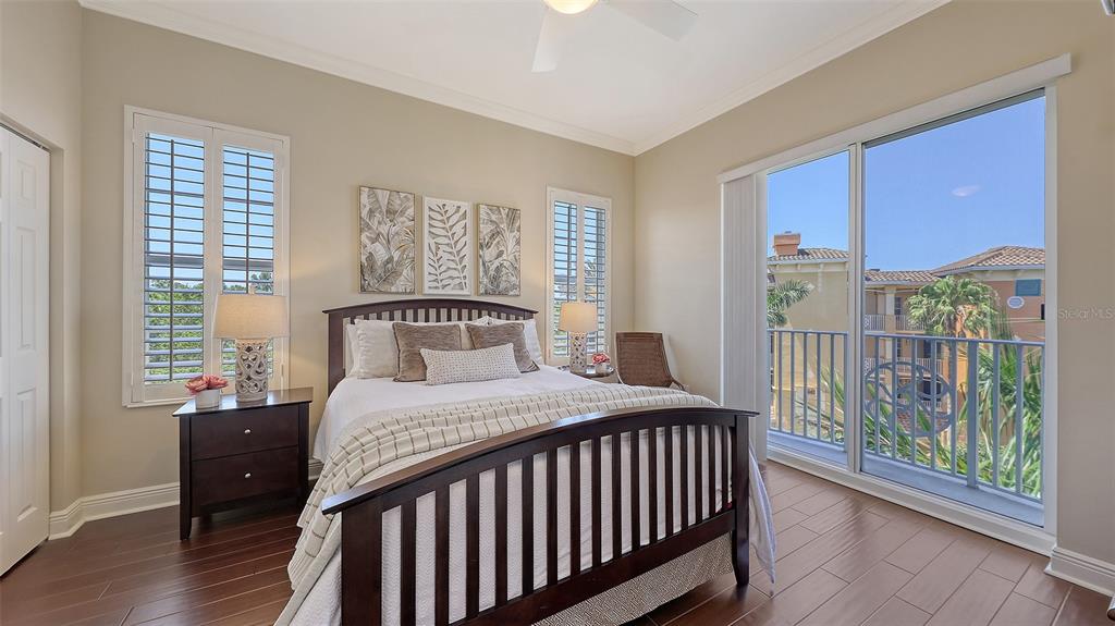 6465 Water Crest Way, Unit 404 Lakewood Ranch, FL 34202 - Photo 33 of 62 a bedroom with a bed and a large window