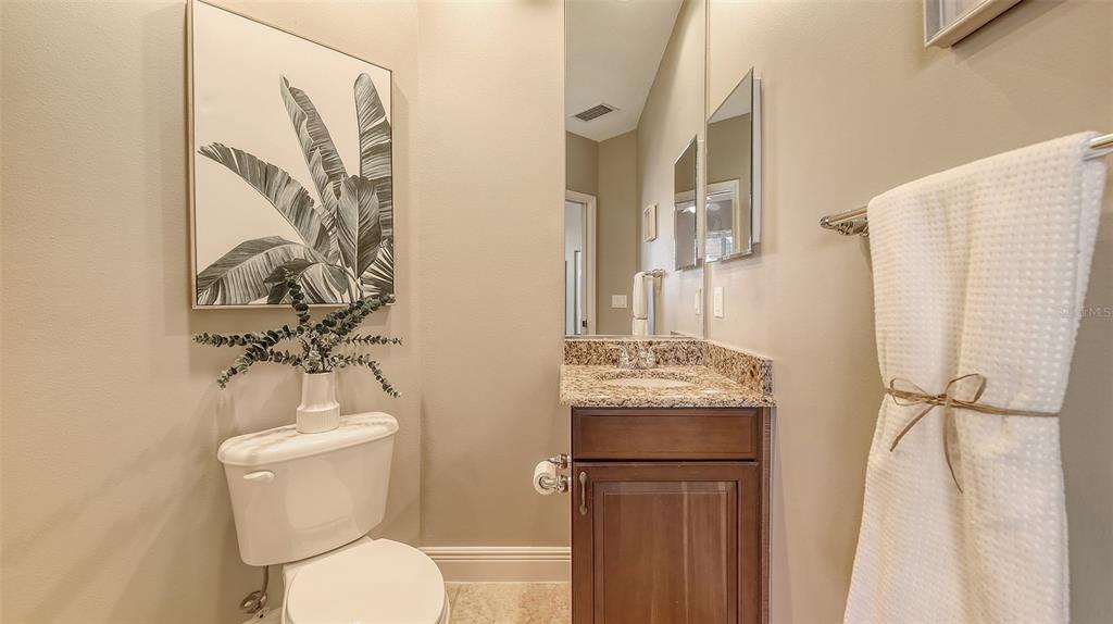 6465 Water Crest Way, Unit 404 Lakewood Ranch, FL 34202 - Photo 42 of 62 a bathroom with a toilet sink and mirror