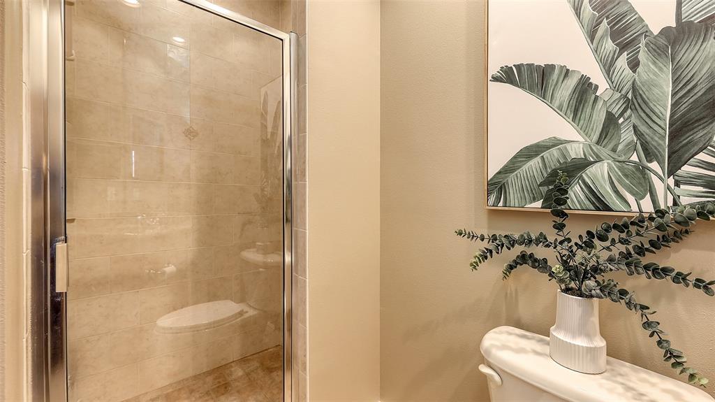 6465 Water Crest Way, Unit 404 Lakewood Ranch, FL 34202 - Photo 43 of 62 a bathroom with a toilet and a shower