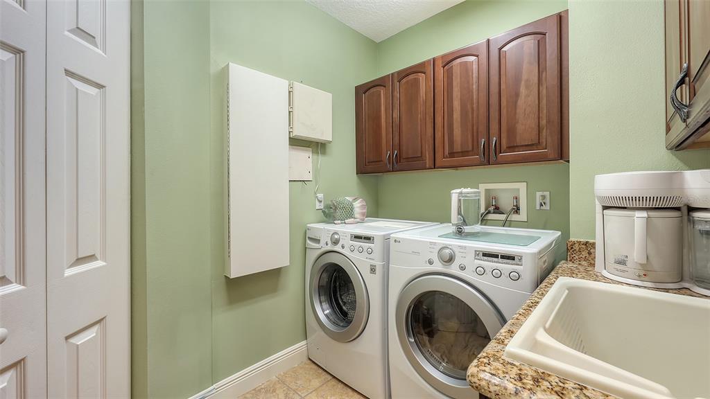 6465 Water Crest Way, Unit 404 Lakewood Ranch, FL 34202 - Photo 44 of 62 a utility room with dryer and washer