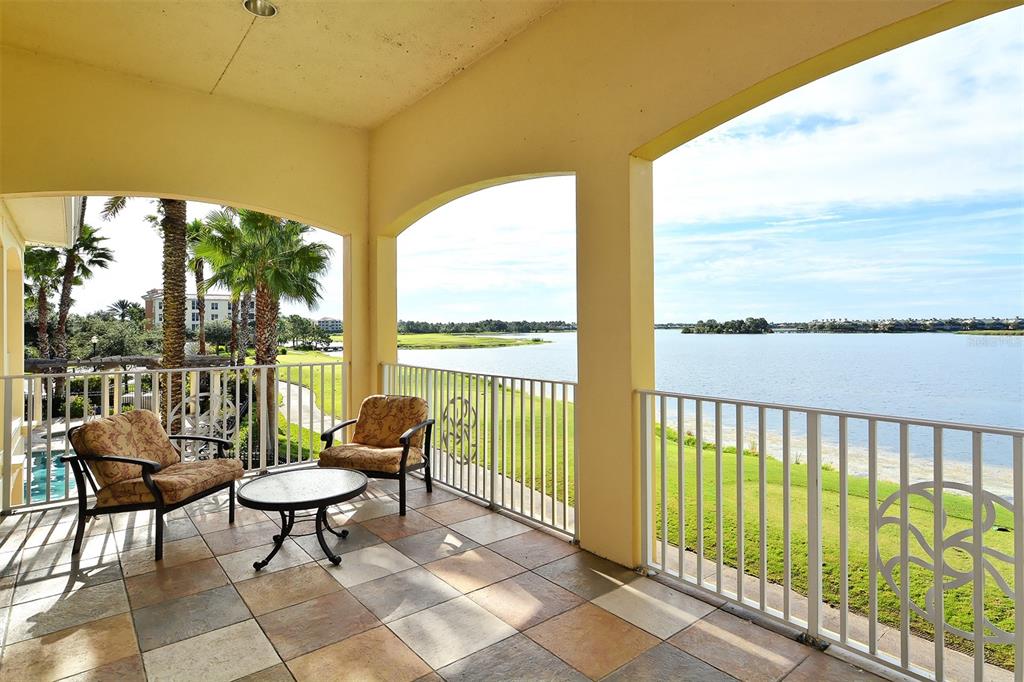 6465 Water Crest Way, Unit 404 Lakewood Ranch, FL 34202 - Photo 60 of 62 a balcony with couple of chairs and a couch