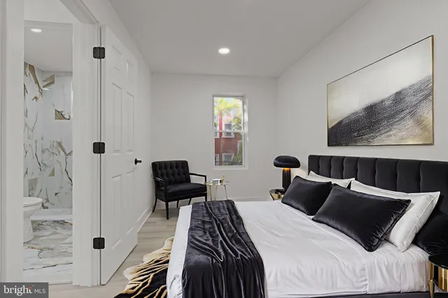 a bedroom with a bed and a painting on the wall