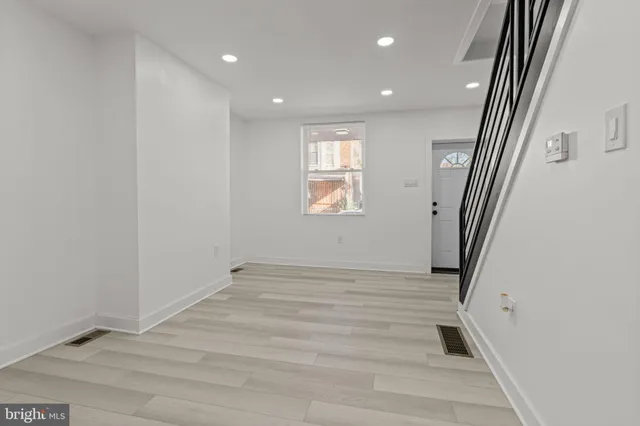 a view of an empty room and a window