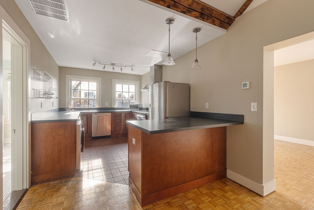 14 Chestnut Street, Unit 4 Boston, MA 02108 - Photo 8 of 12 a view of a kitchen with refrigerator and windows