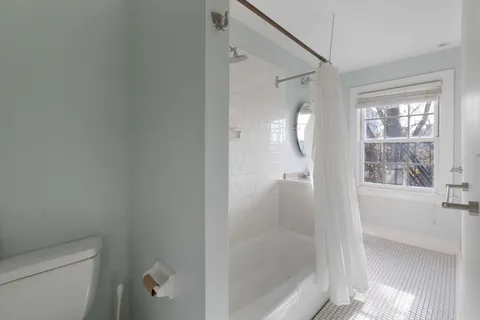 a bathroom with a glass shower door and a toilet