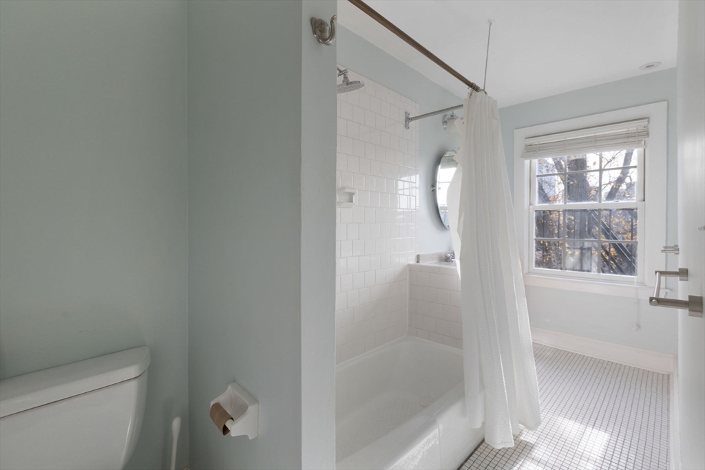 14 Chestnut Street, Unit 4 Boston, MA 02108 - Photo 10 of 12 a bathroom with a glass shower door and a toilet
