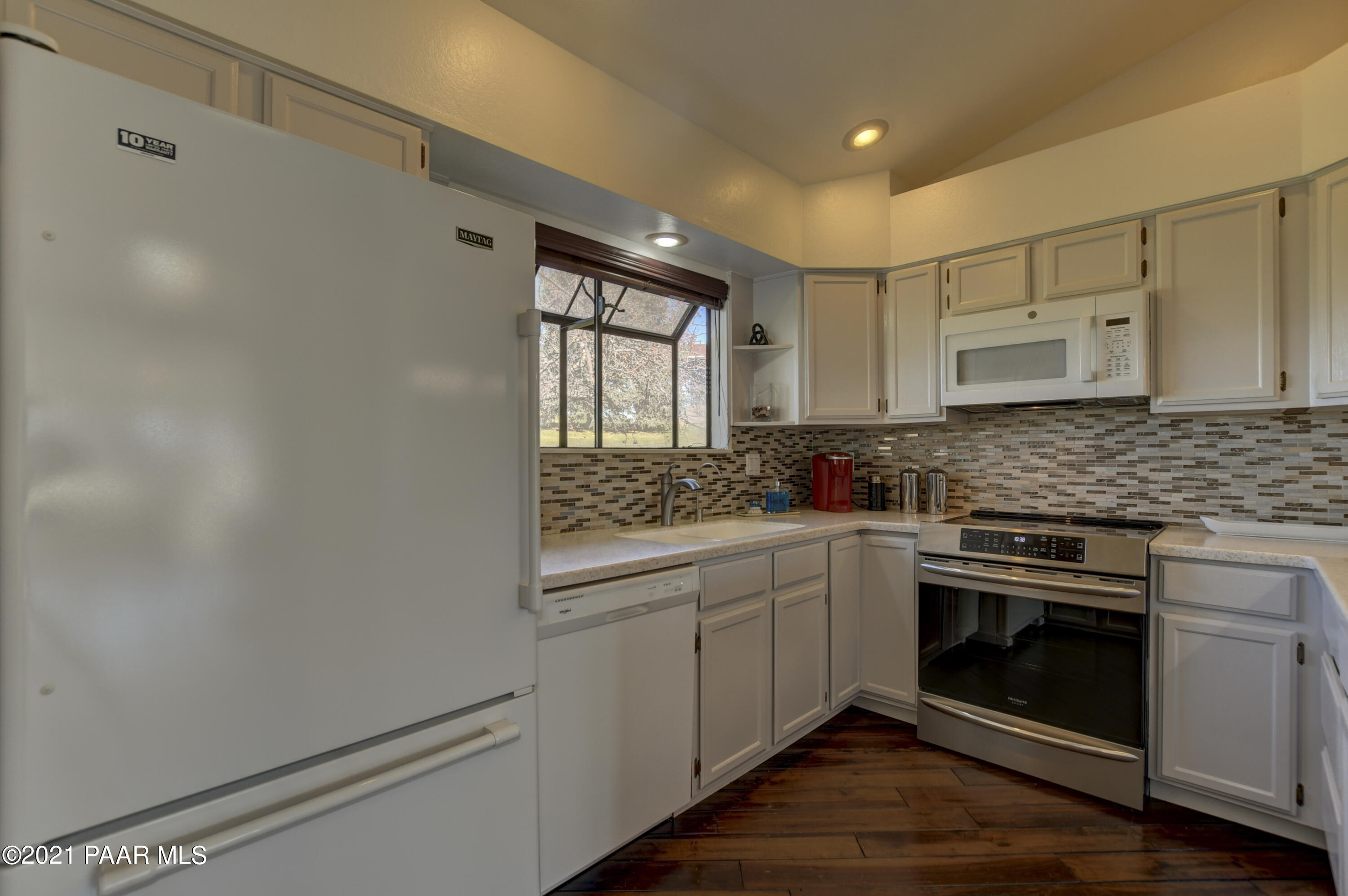 1034 Bunker Place Dewey, AZ 86327 - Photo 12 of 40 a kitchen with white cabinets and appliances