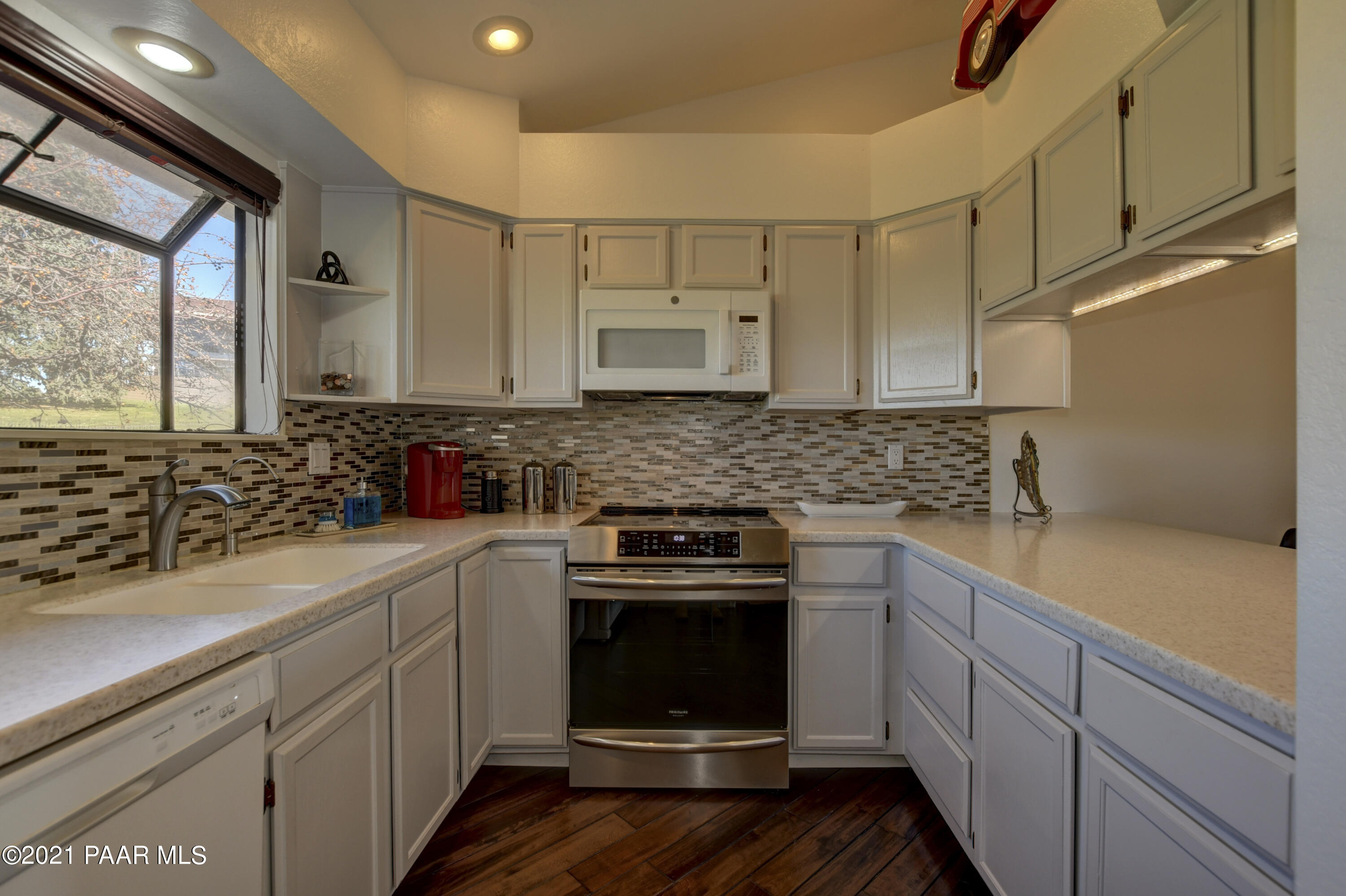 1034 Bunker Place Dewey, AZ 86327 - Photo 13 of 40 a kitchen with a sink stove and cabinets