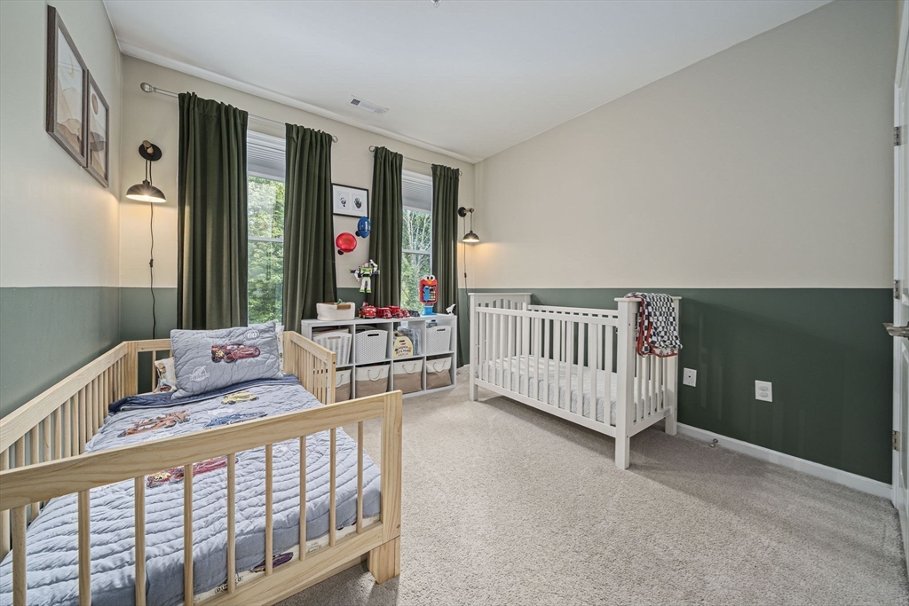 70 Trotter Road, Unit 310 Weymouth, MA 02190 - Photo 11 of 14 a bedroom with furniture and baby crib