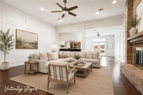 a living room with furniture wooden floor and a flat screen tv