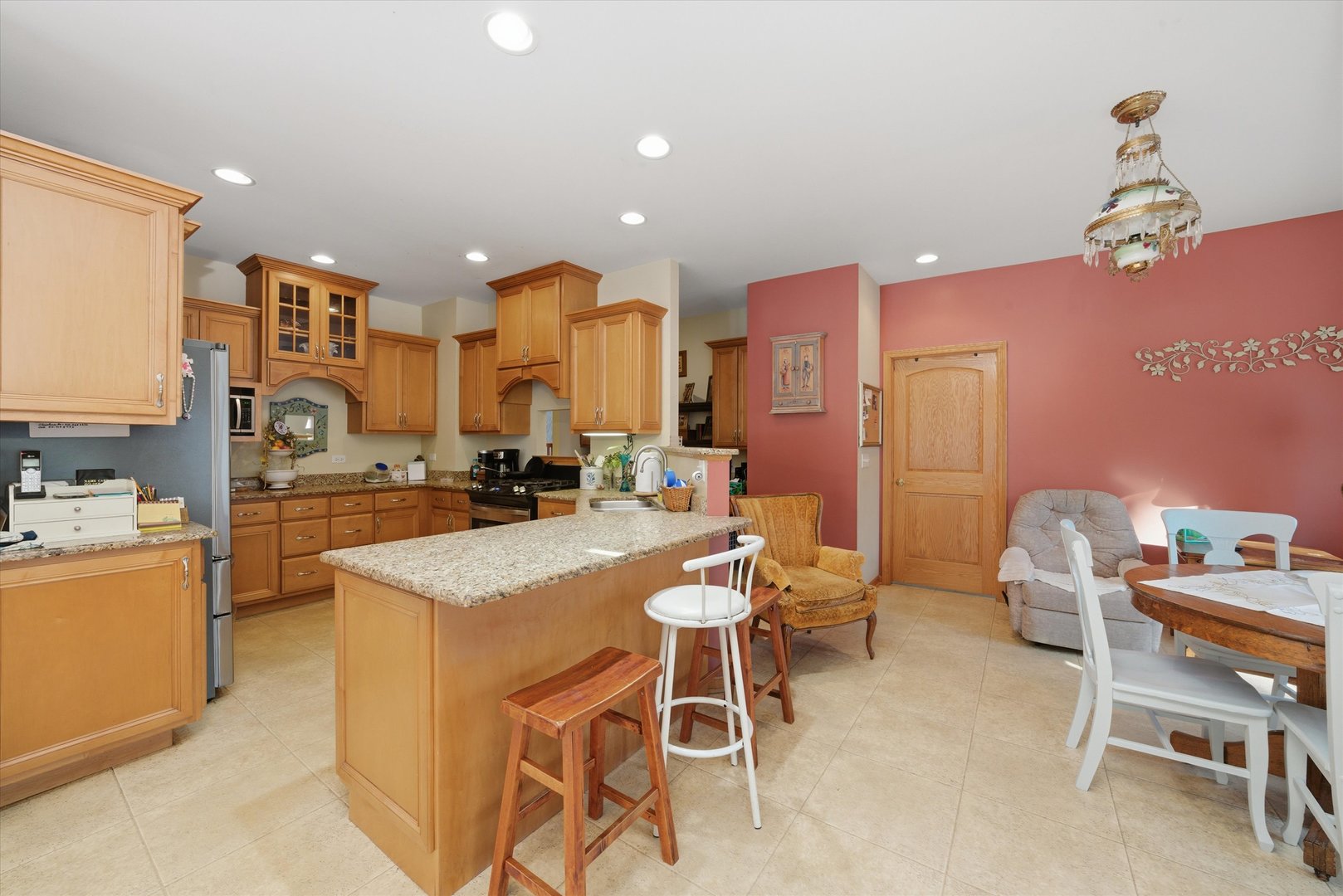 17305 West 145th Street Lockport, IL 60441 - Photo 14 of 29 a kitchen with stainless steel appliances kitchen island granite countertop a sink a stove and a refrigerator