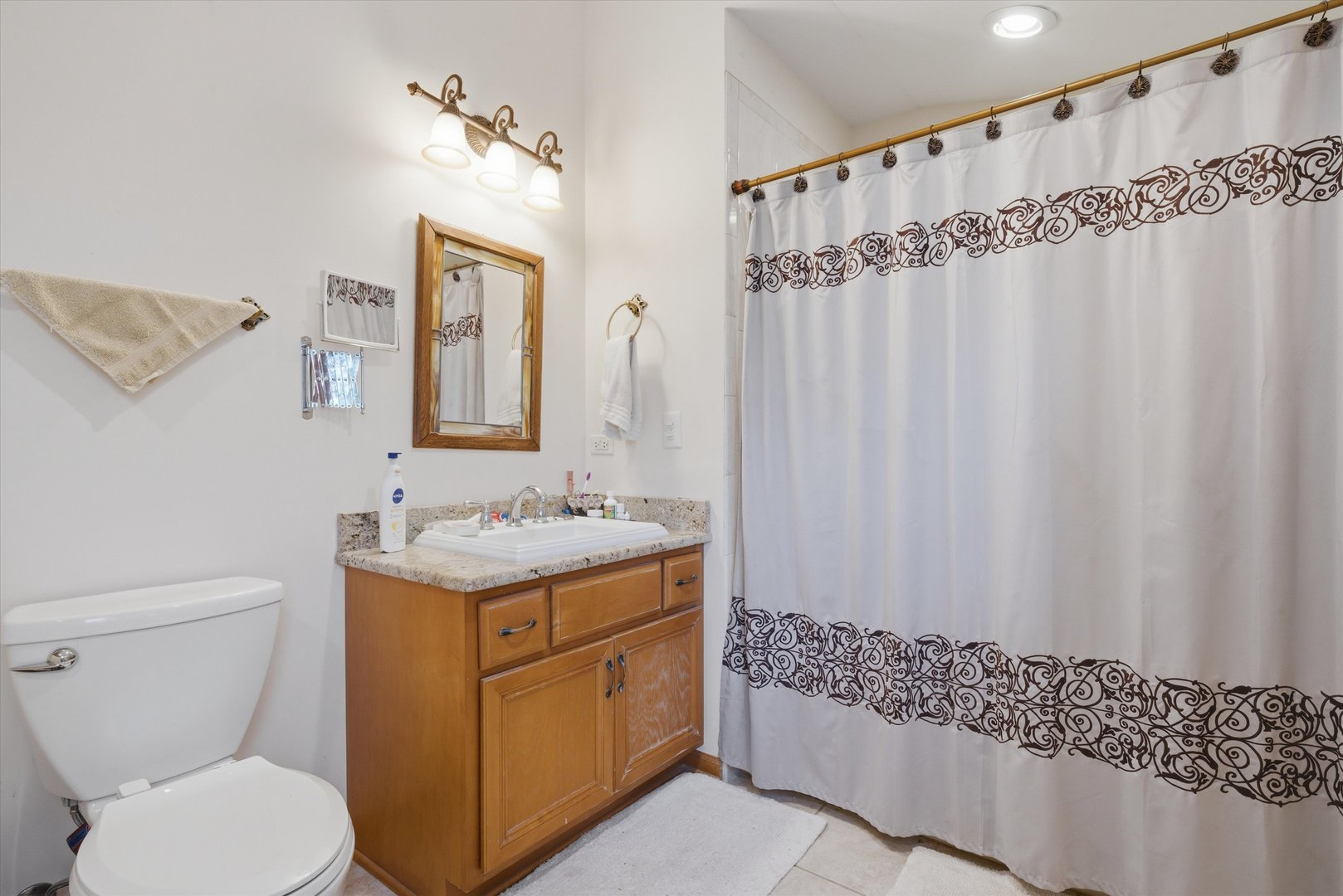17305 West 145th Street Lockport, IL 60441 - Photo 18 of 29 a bathroom with a granite countertop sink a toilet and a mirror