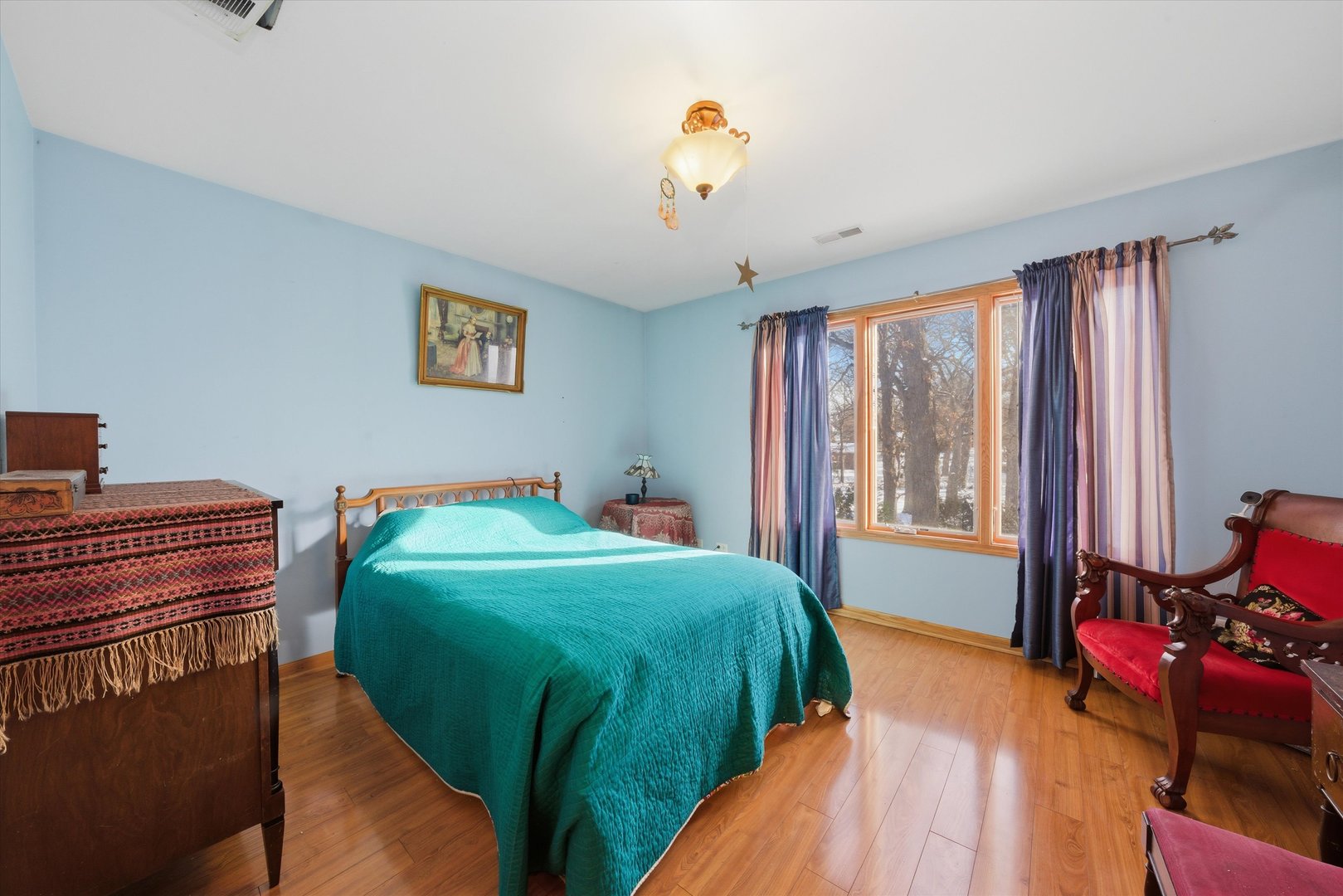 17305 West 145th Street Lockport, IL 60441 - Photo 21 of 29 a bedroom with a bed and a chandelier