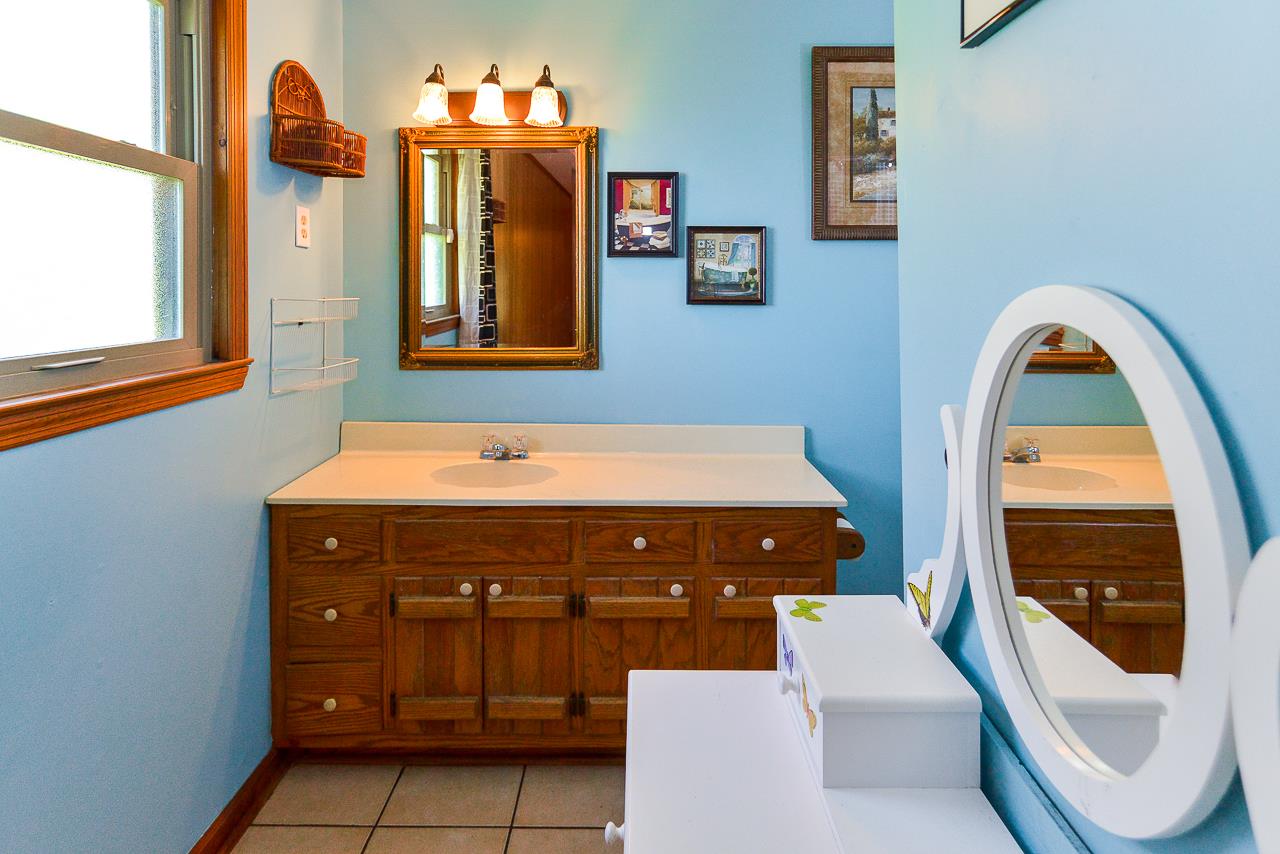 469 Limestone Road Elora, TN 37328 - Photo 24 of 30 a bathroom with a sink a vanity and a mirror