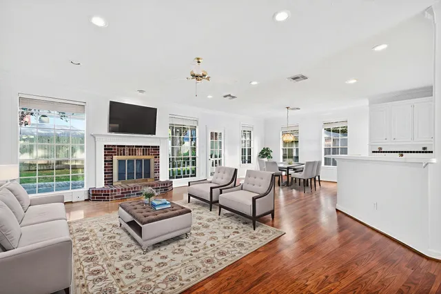 a living room with fireplace furniture and a flat screen tv