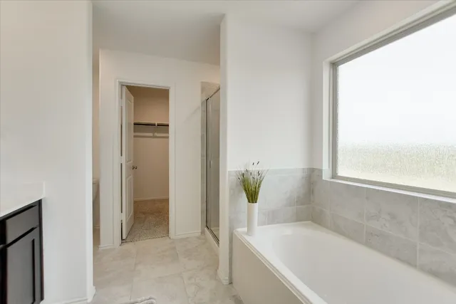 a bathroom with a tub and shower