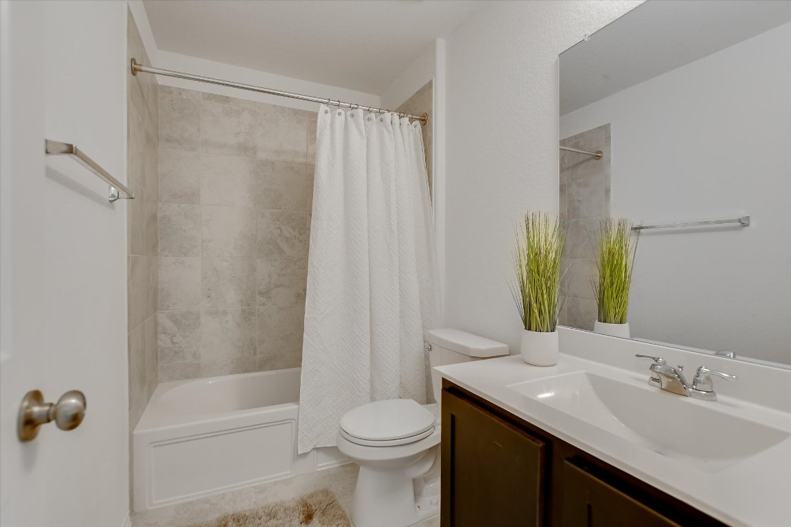 561 Greatest Gift Way Jarrell, TX 76537 - Photo 18 of 32 Beautiful tile sets a warm tone in the bathroom between bedrooms 2 & 3.