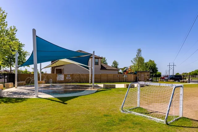 a swimming pool with outdoor seating and yard