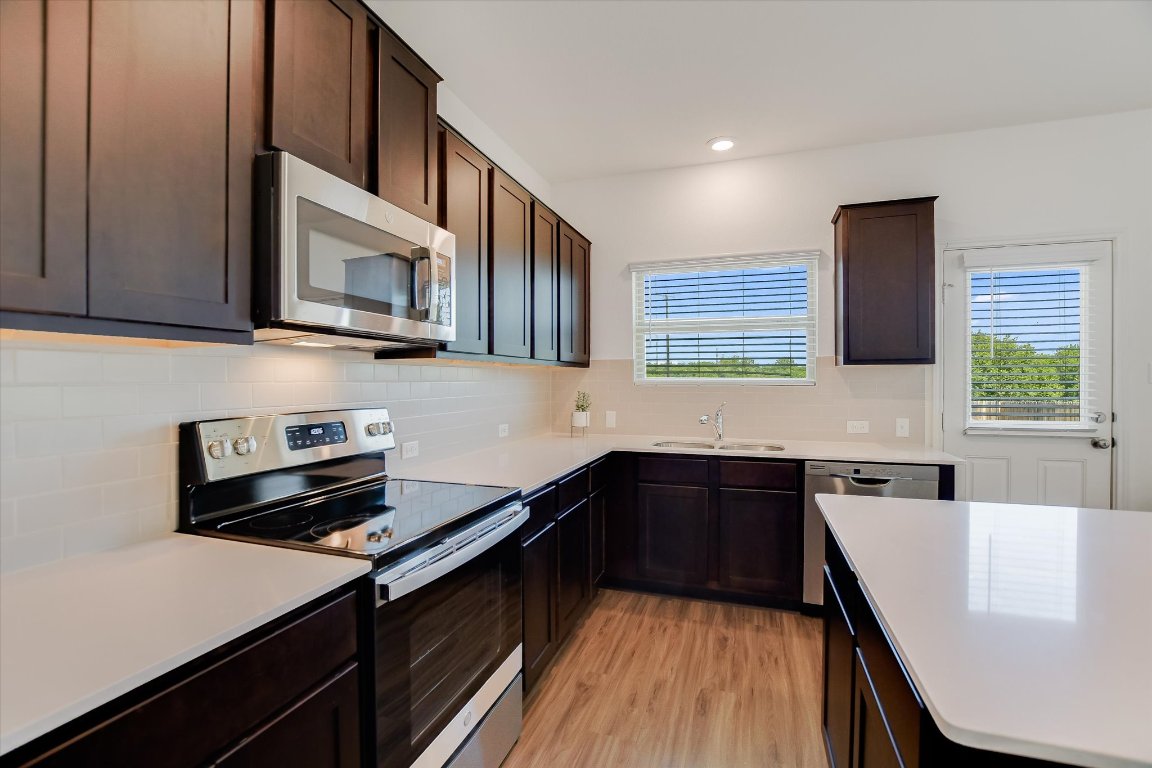 561 Greatest Gift Way Jarrell, TX 76537 - Photo 10 of 32 Plenty of cabinets and a large pantry store your kitchen essentials.