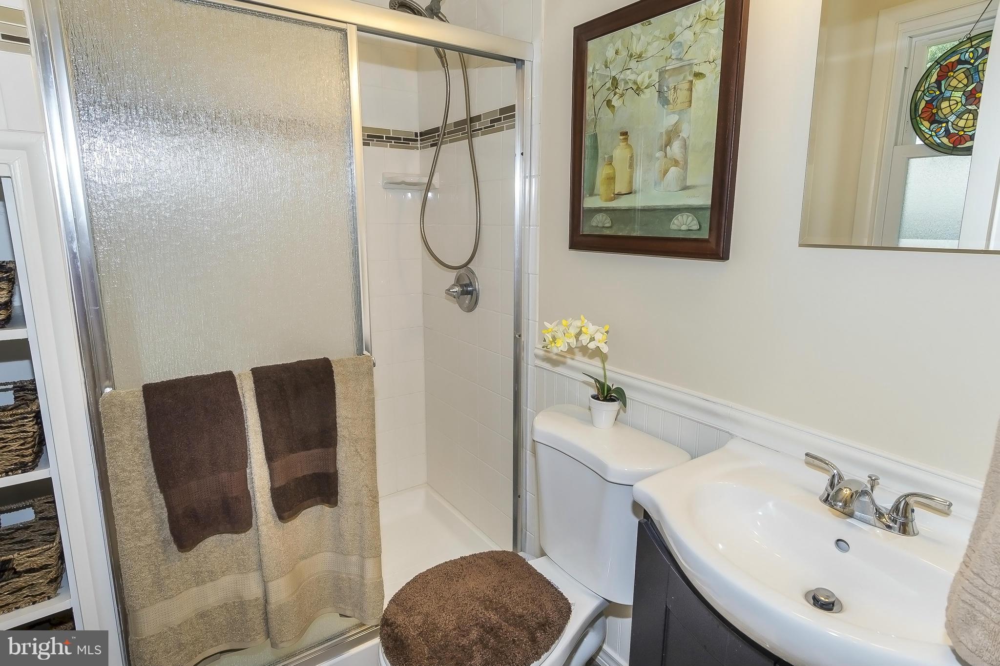 1747 Tacoma Road Edgewater, MD 21037 - Photo 11 of 19 a bathroom with a sink and mirror with toilet