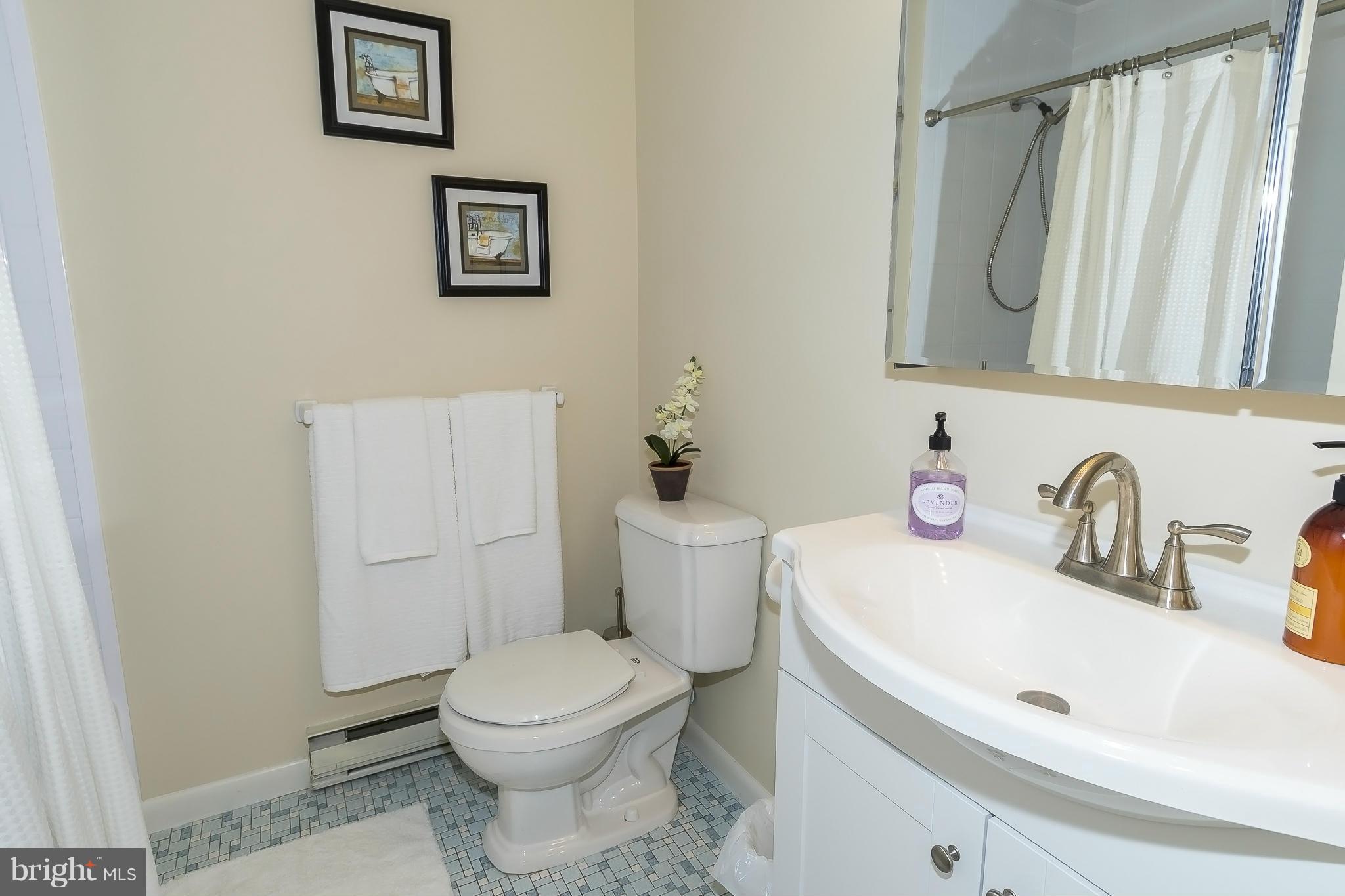 1747 Tacoma Road Edgewater, MD 21037 - Photo 14 of 19 a bathroom with a toilet sink and mirror