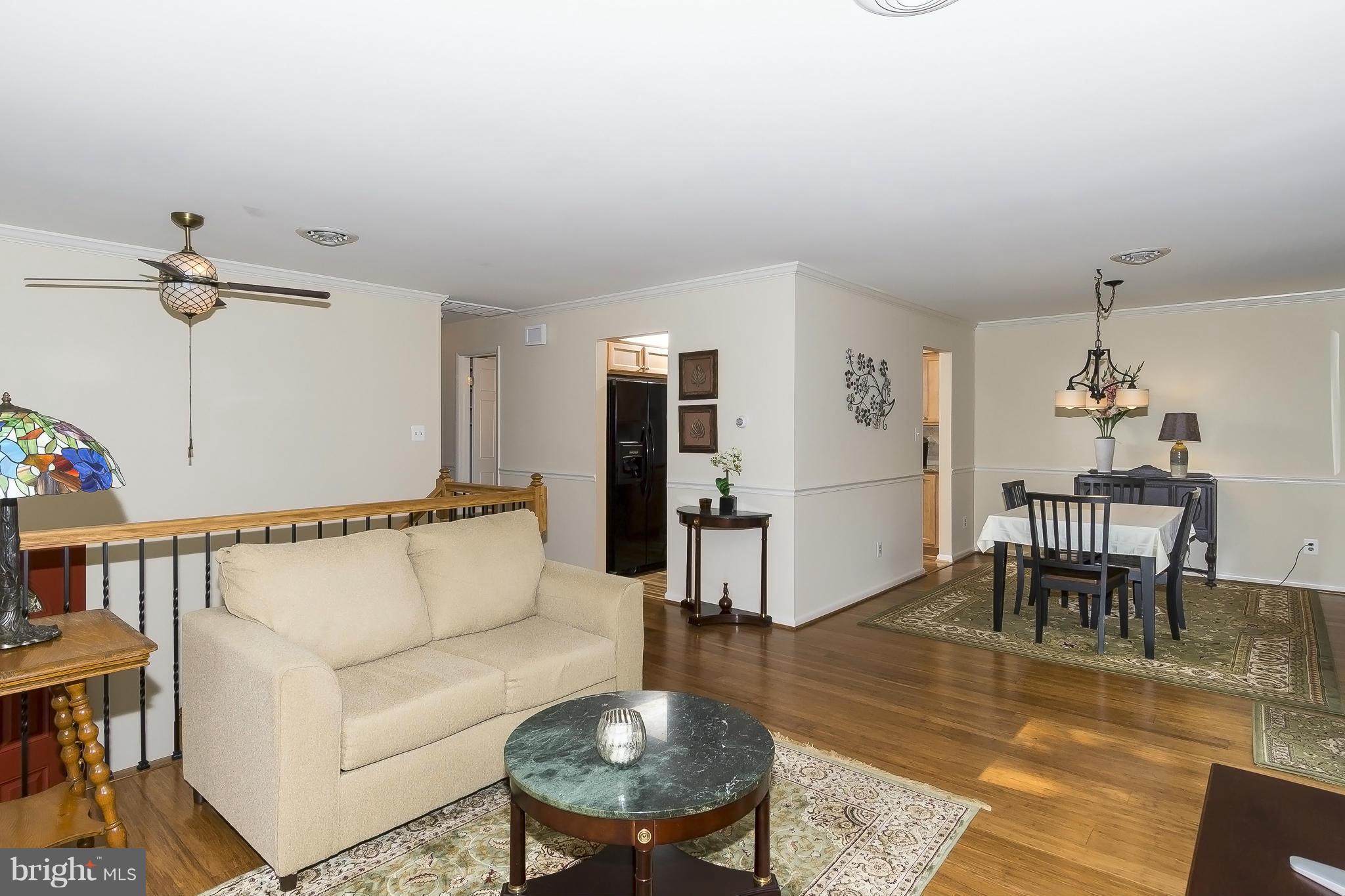 1747 Tacoma Road Edgewater, MD 21037 - Photo 4 of 19 a living room with furniture and a dining table with white walls