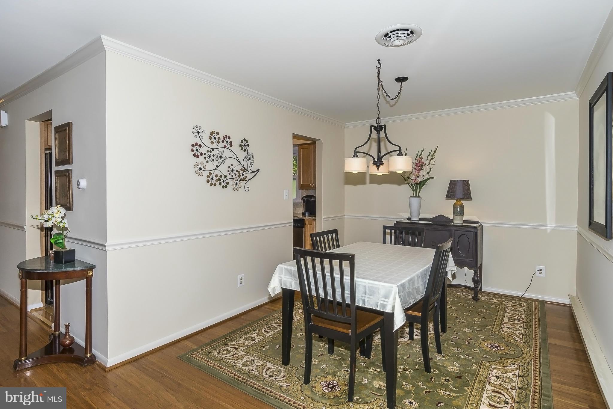1747 Tacoma Road Edgewater, MD 21037 - Photo 5 of 19 a dining room with furniture a chandelier and wooden floor