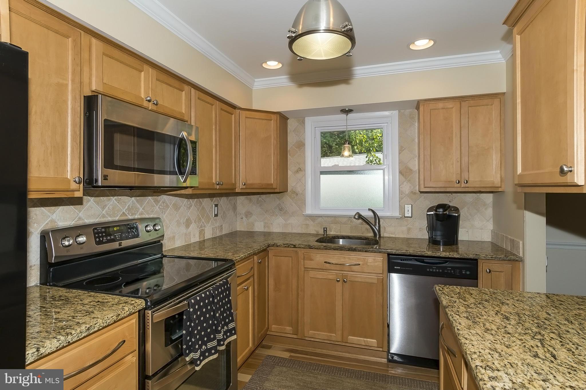 1747 Tacoma Road Edgewater, MD 21037 - Photo 6 of 19 a kitchen with stainless steel appliances granite countertop a stove microwave and sink