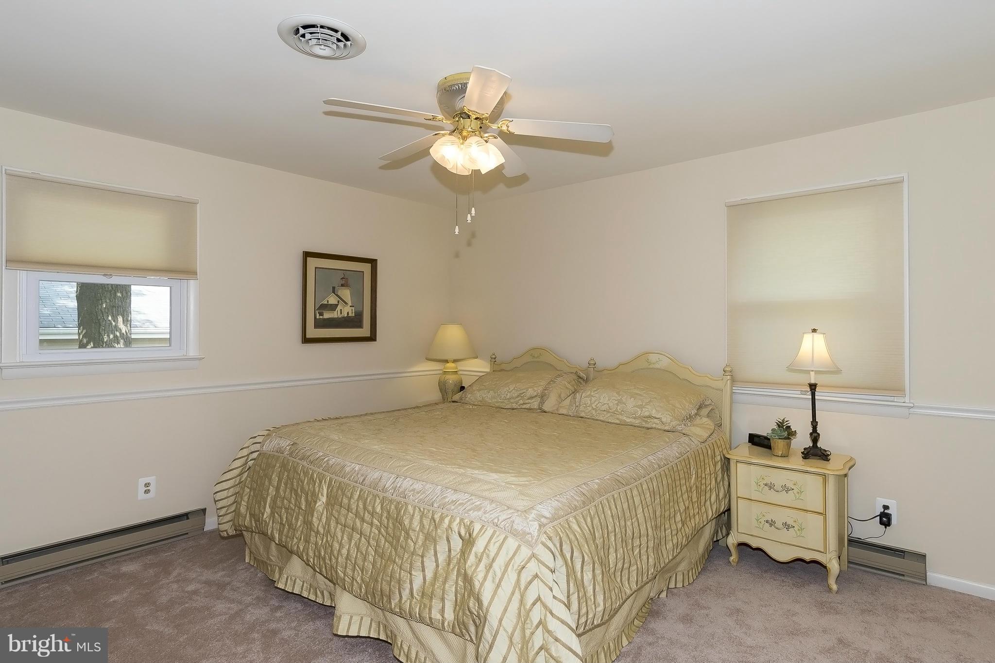 1747 Tacoma Road Edgewater, MD 21037 - Photo 9 of 19 a bedroom with a bed and a chandelier
