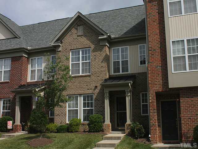 9712 Layla Avenue Raleigh, NC 27617 - Photo 1 of 25 a front view of a house with garden