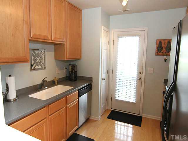 9712 Layla Avenue Raleigh, NC 27617 - Photo 11 of 25 a kitchen with granite countertop a sink and a window