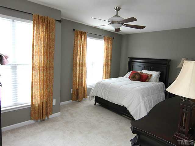 9712 Layla Avenue Raleigh, NC 27617 - Photo 13 of 25 a bedroom with a bed and a window