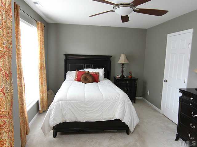 9712 Layla Avenue Raleigh, NC 27617 - Photo 14 of 25 a bedroom with a bed and a window