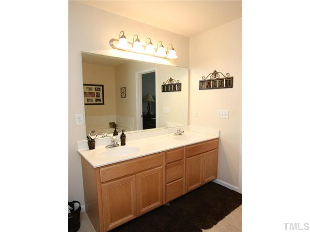 9712 Layla Avenue Raleigh, NC 27617 - Photo 16 of 25 a bathroom with a double vanity sink and mirror