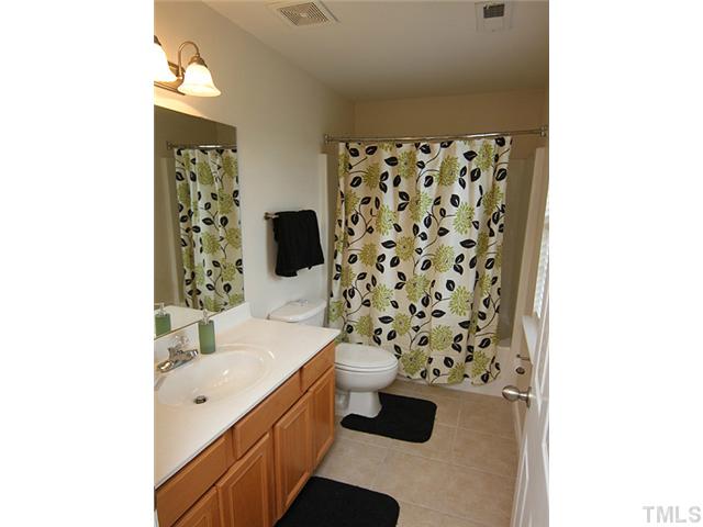 9712 Layla Avenue Raleigh, NC 27617 - Photo 21 of 25 a spacious bathroom with a shower and a sink